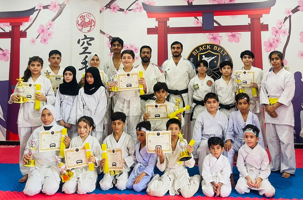 Official Dan belt grading ceremony with certificates and trophies